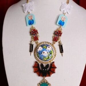 A necklace with an earth and flowers on it.