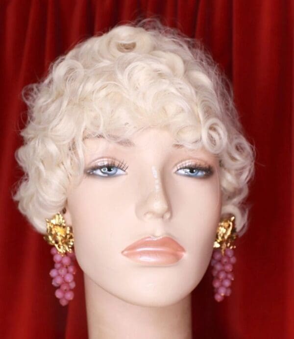 A mannequin wearing earrings and a wig.