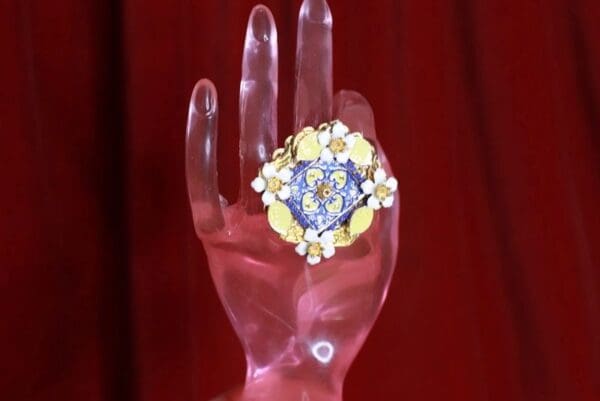 A hand holding something with a heart on it
