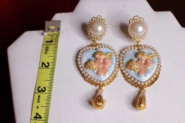 A pair of earrings with a measuring tape and ruler