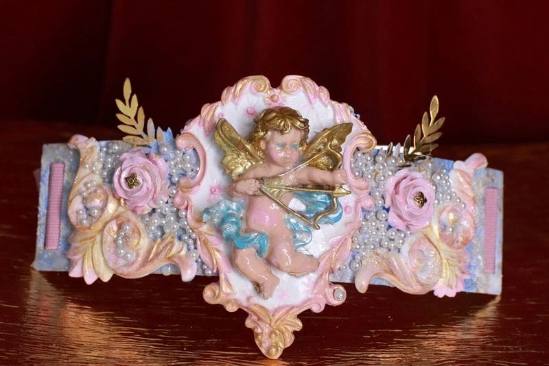 A close up of a decorative angel on top of a table.