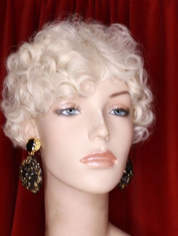 A mannequin with white hair and earrings.