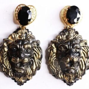 A pair of earrings with black stones and gold accents.