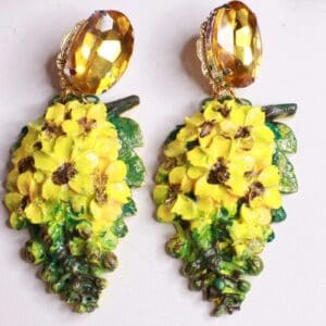 A pair of yellow and green earrings with gold accents.