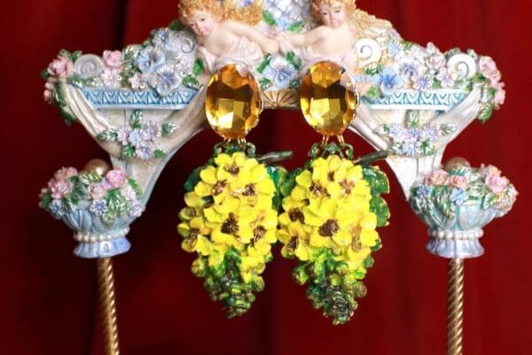 A pair of yellow earrings hanging from the ceiling.