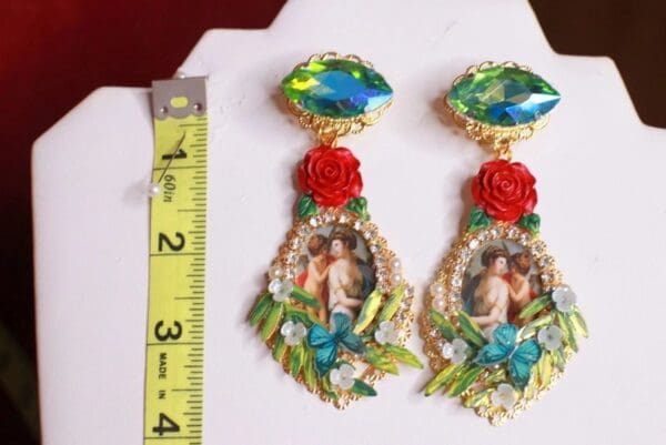 A pair of earrings with a picture on them