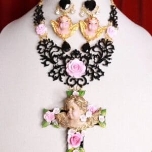 A necklace and earrings set with pink roses.