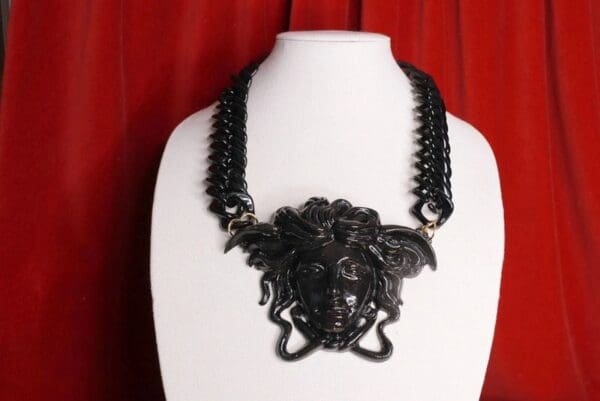 A black necklace with an elephant head on it