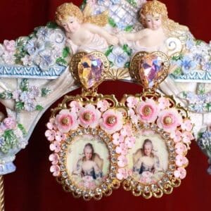 A pair of earrings with pictures on them hanging from the side of a wall.