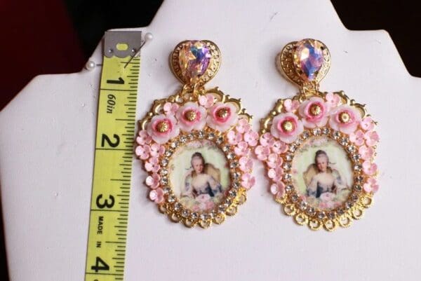 A pair of earrings with a picture on them