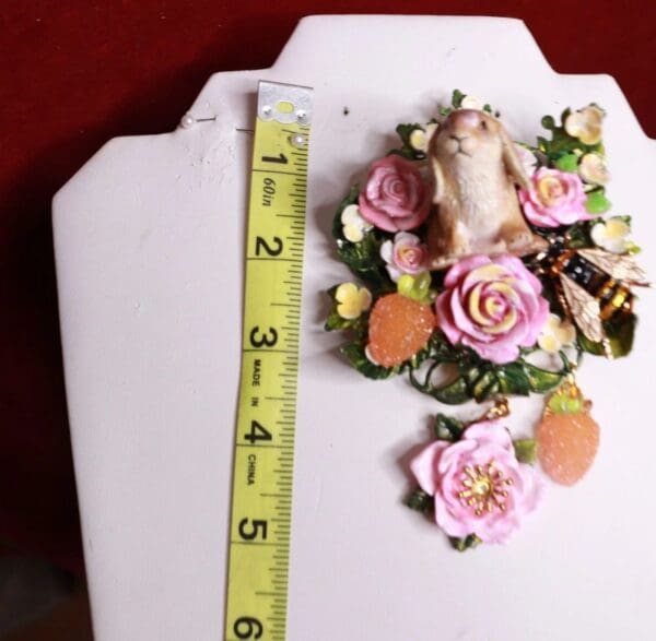 A ruler and some flowers on top of a table.
