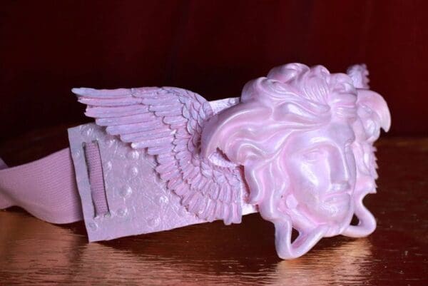 A close up of the head and wings of an angel.