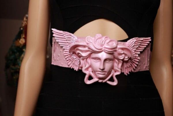 A close up of the head of a woman wearing a pink belt