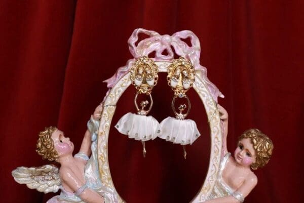 A pair of earrings sitting on top of a frame.