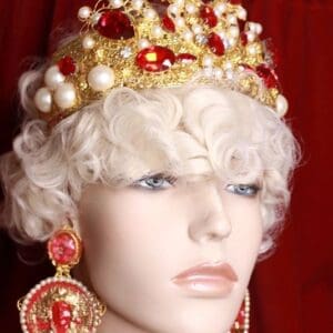 A mannequin wearing a crown and earrings.