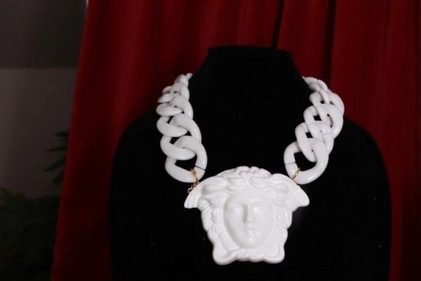 A white necklace with a face on it