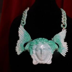 A necklace with an image of a head and wings.