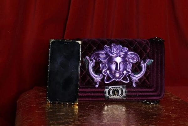 A purple purse sitting on top of a table.