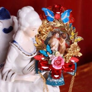 A porcelain figurine of a woman holding a wreath.