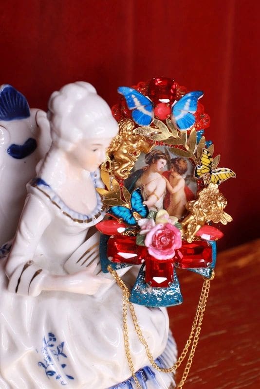 A porcelain figurine of a woman holding a wreath.