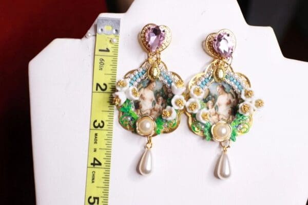 A pair of earrings with a measuring tape and ruler