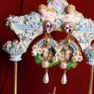 A pair of earrings on top of a stand.