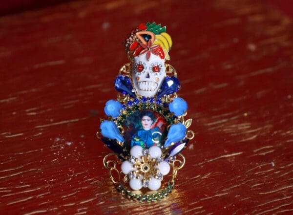 A small skull with blue and yellow beads on it.