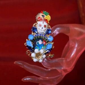 A hand holding something with blue flowers on it.