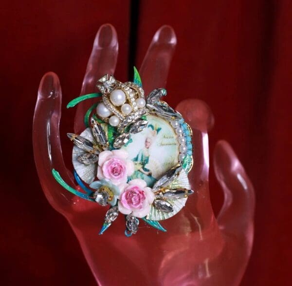A hand holding something with flowers on it