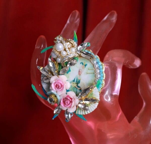 A hand holding a plate with flowers on it