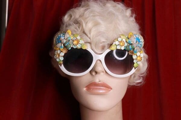 A mannequin wearing sunglasses with flowers on them.