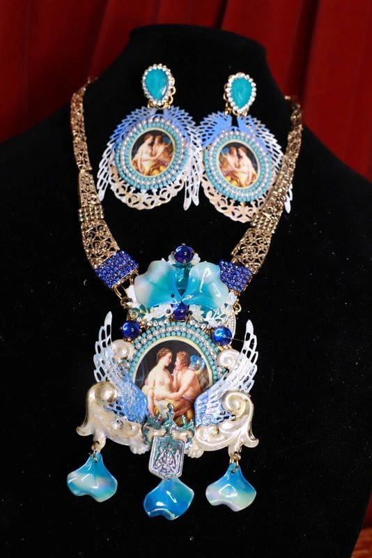 A woman wearing a necklace and earrings with pictures of her face.