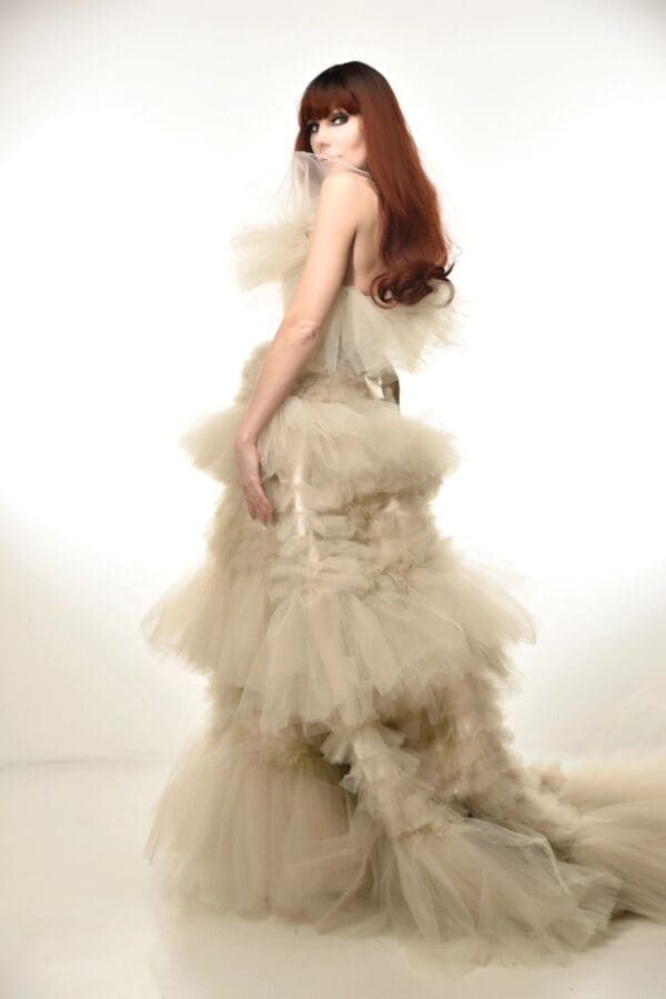 A woman in a white dress standing on top of a floor.