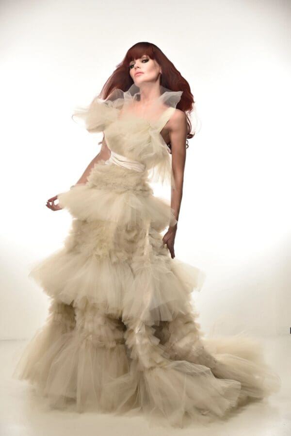 A woman in a white dress posing for the camera.