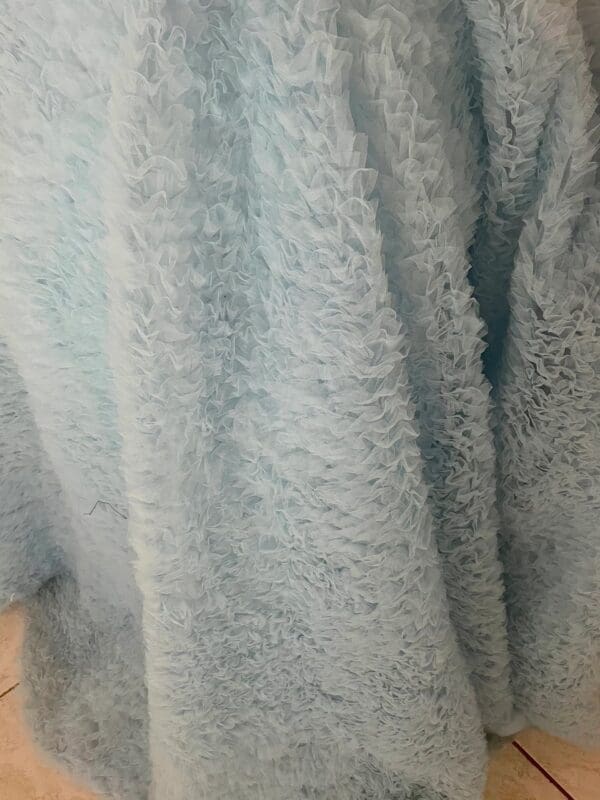 A close up of the fabric in a blue blanket