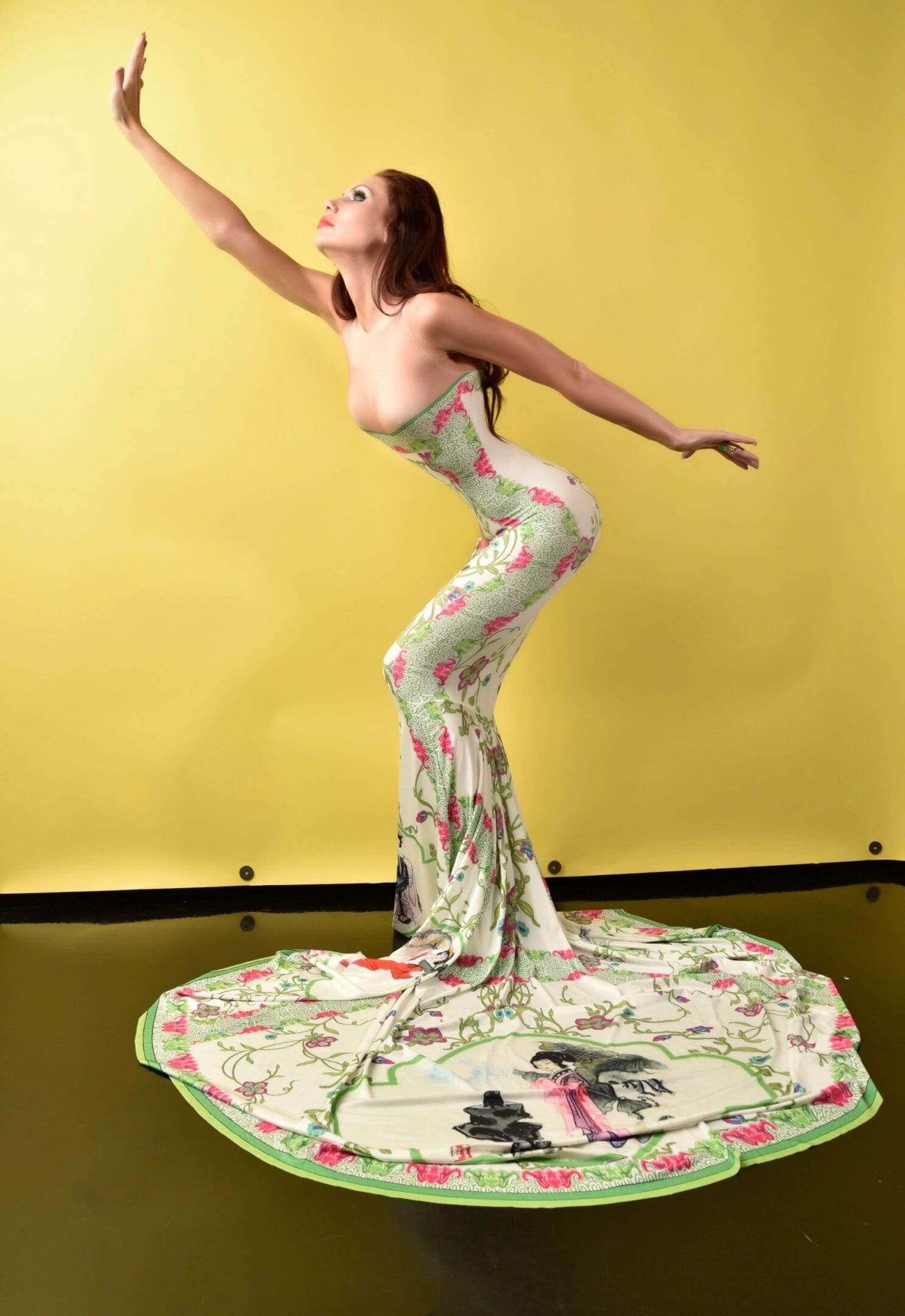 A woman in a dress is standing on the floor