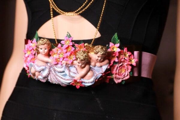 A close up of a purse with three little angels