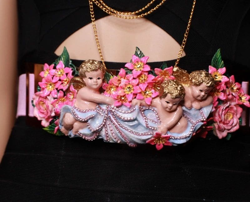 A close up of a purse with three angels