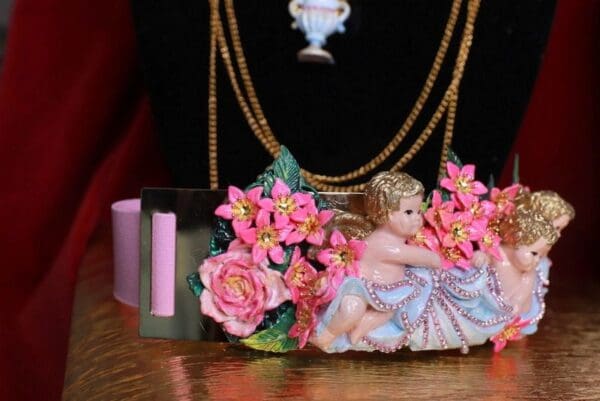 A close up of a necklace with a doll on it