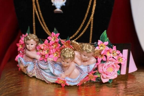 A group of three little angels sitting on top of a table.