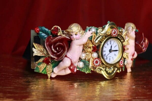A clock with a cupid and rose on it.
