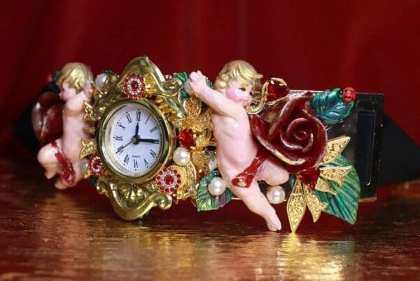 A clock with cherubs and roses on it.