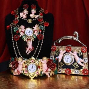A table with three different jewelry and a clock.