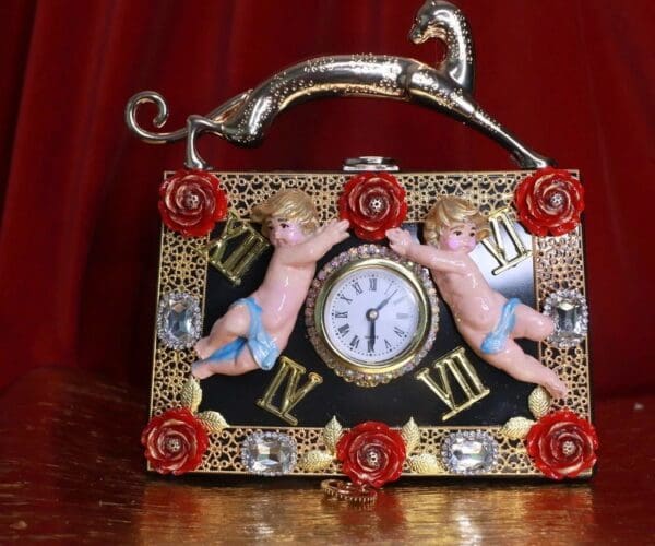 A picture of an ornate clock with two angels on it.