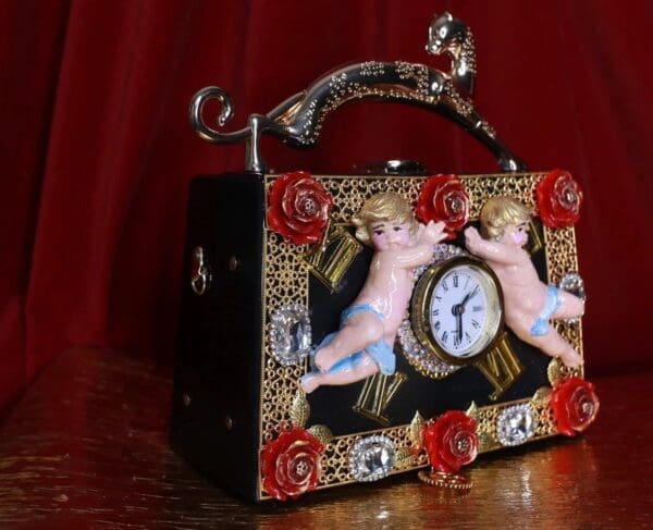 A wooden box with a clock and angels on it.