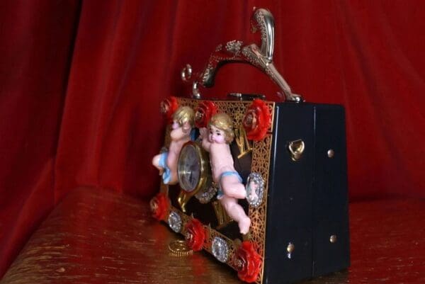 A close up of a purse with two angels on it
