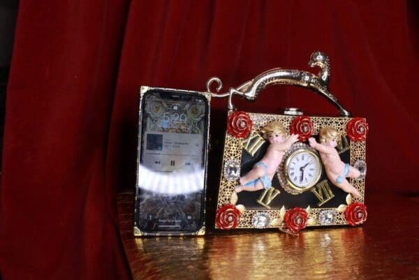 A phone and purse sitting on top of a table.