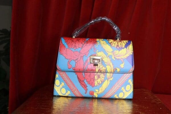A colorful purse sitting on top of a table.
