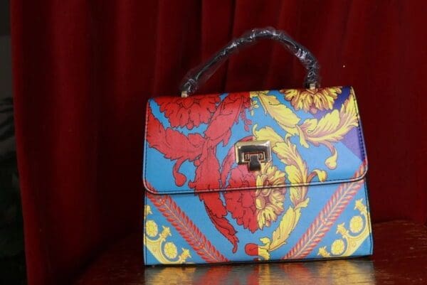 A colorful purse sitting on top of a table.