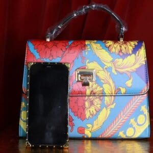 A purse and cell phone sitting on top of a table.